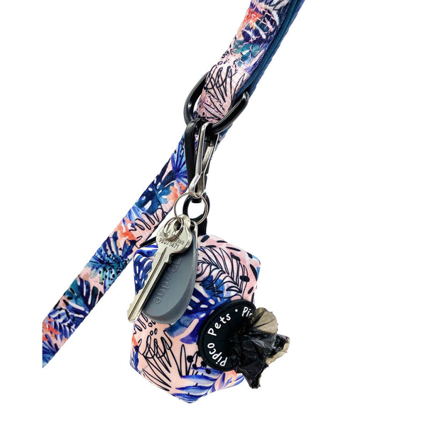 Load image into Gallery viewer, Pipco Pets tropical pattern dog poo bag dispenser with dog poo bags poking out, attached to leash along with keys